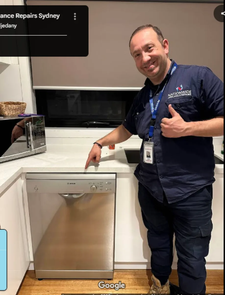 A NAR technician standing in front of a Bosch dishwasher, giving a thumb up.