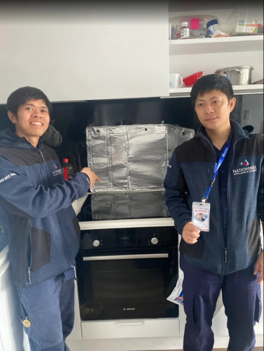Two NAR technicians with an electric Bosch oven.