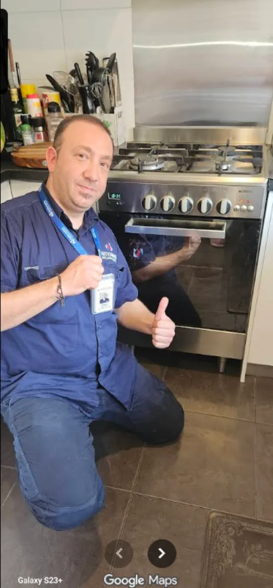 NAR technician standing in front of a dual fuel oven in a client’s home.
