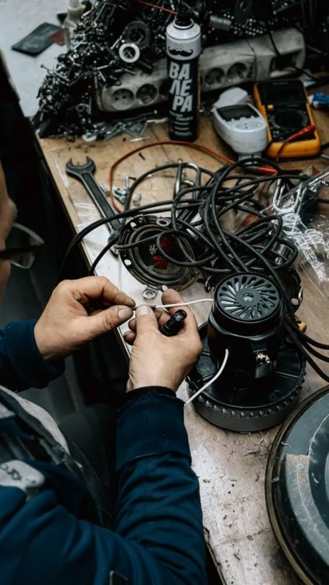 Technician repairing electrical equipment.