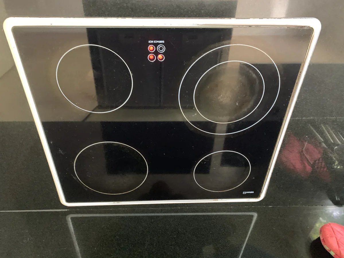 Ceran-branded induction electric cooktop with power lights on.