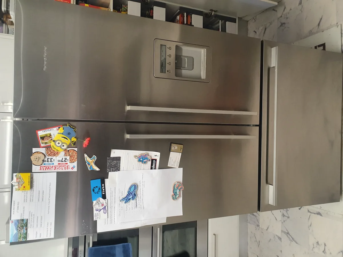 fisher-paykel-refrigerator-1 Fisher & Paykel refrigerator with a lot of notes and fridge magnets in a NAR’s client’s home.