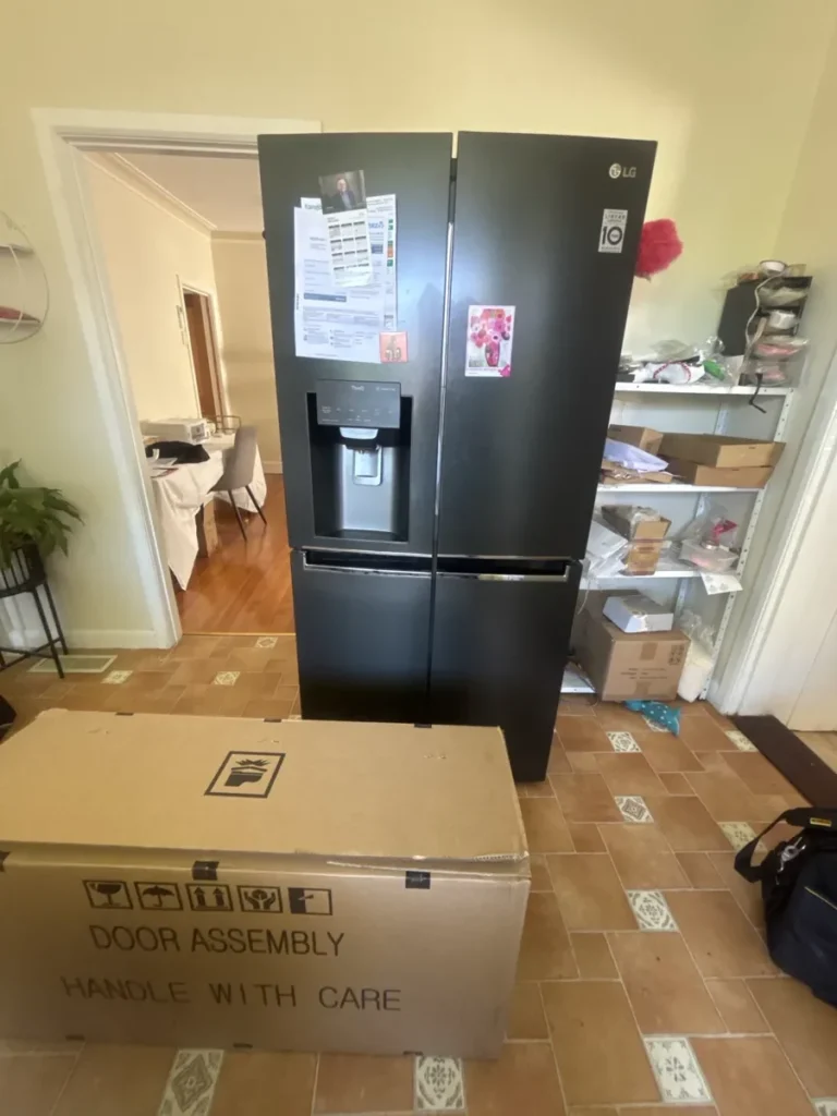 LG fridge with different papers and stickers attached to it in a NAR’s client home.