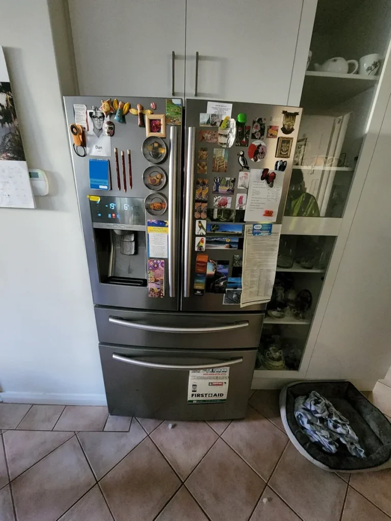 Samsung fridge with a lot of stickers and magnets in a NAR’s client home.