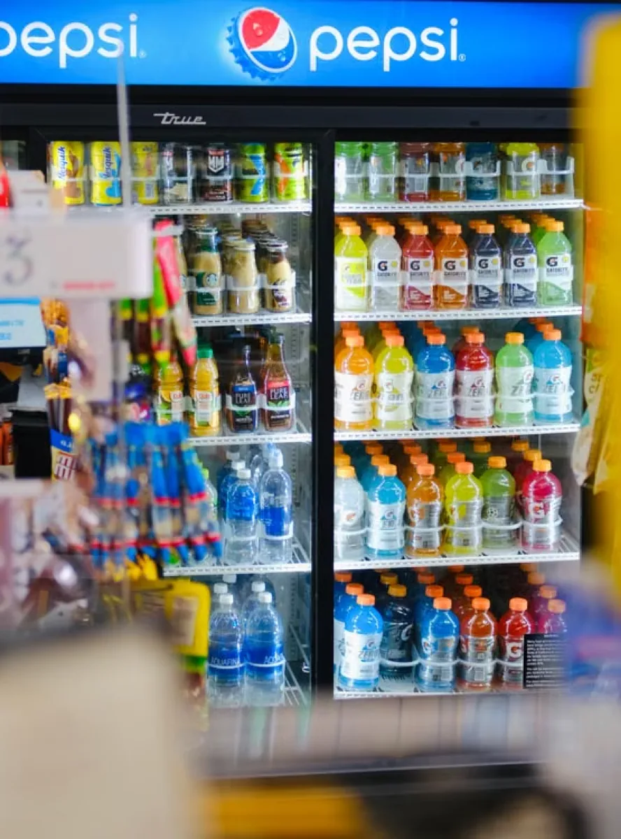 A commercial refrigerator holding assorted drink products.
